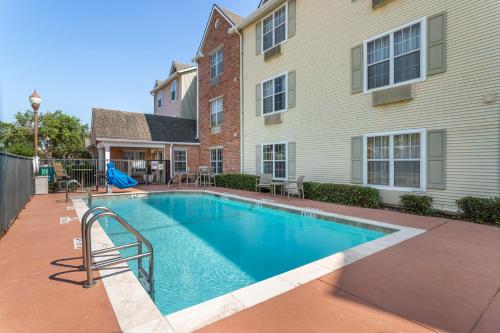 a swimming pool in the backyard of a house at MainStay Suites Houston NASA-Clear Lake in Webster