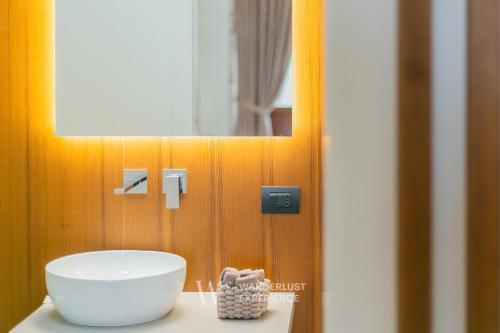 a bathroom with a bowl on a counter with a mirror at Wanderlust Experience White Cave in Bitonto
