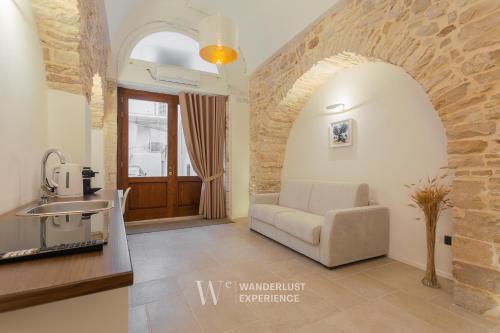 a living room with a couch and a table at Wanderlust Experience White Cave in Bitonto