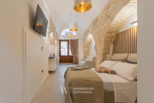 a bedroom with a large bed in a room at Wanderlust Experience White Cave in Bitonto