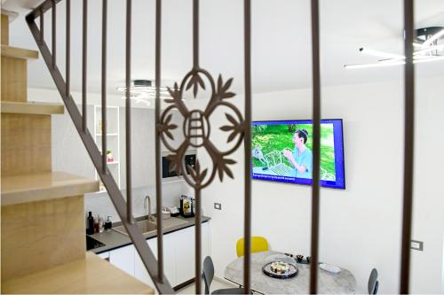 a living room with a tv on a wall at Locazione Turistica Arcobaleno "Appartamento Deluxe" in Roccavivara