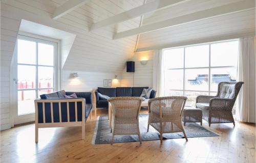 a living room with a couch and chairs and windows at Amazing Home In Blåvand With Wifi in Blåvand