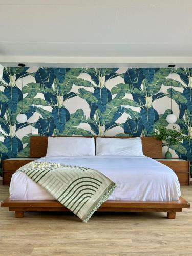 a bedroom with a bed with a blue and white wallpaper at Panoramic Oceanview Resort - Full Kitchen in Each Unit, 2 Swimming Pools, Onsite Restaurants, Fireworks Every Friday in Honolulu