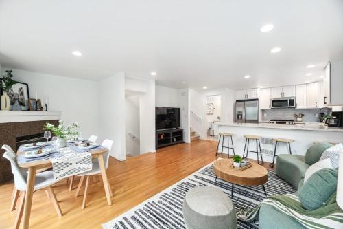 a living room with a couch and a table at Green Lake Remodelled home with AC garage yard in Seattle