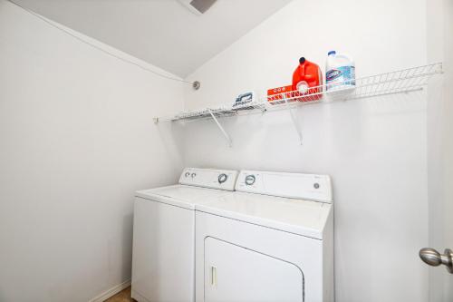 a white laundry room with a washer and dryer at Green Lake Remodelled home with AC garage yard in Seattle