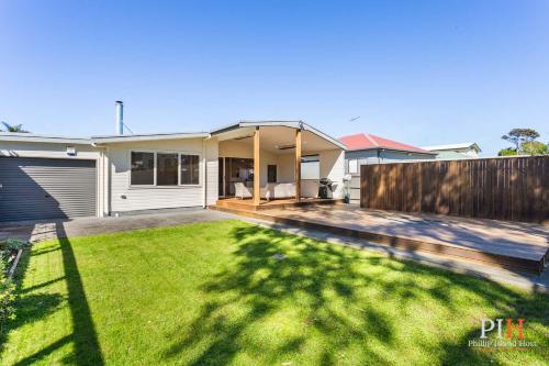 a house with a yard with a fence at Renovated Lux Property in Quiet Estate in Cowes