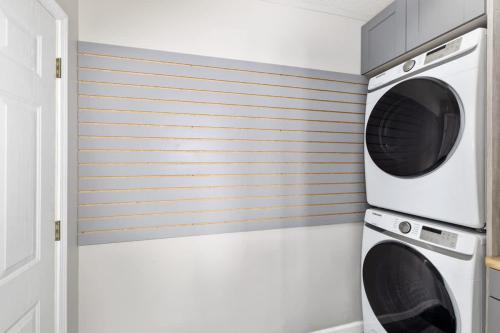 a laundry room with two washer and dryer at Lakefront Home with Dock Firepit & Private Deck in Grand Junction