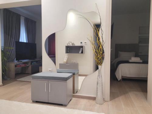 a living room with a table and a vase of flowers at Luxury Captain's Corner in Trikala, 3BD in Tríkala