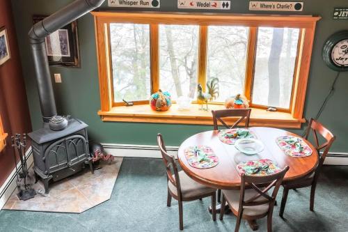 a dining room with a table and a stove at Cozy Rustic Bliss Seconds from Windham Mt Resort in Windham