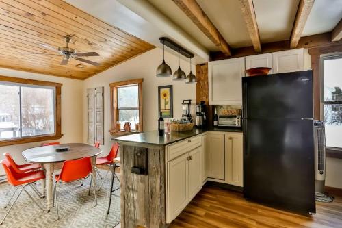 a kitchen with a black refrigerator and a table at Majestic Mountain Retreat with Fire Pit Facing Mtn in Hunter