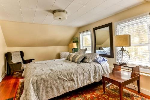 a bedroom with a bed and a table and a mirror at Majestic Mountain Retreat with Fire Pit Facing Mtn in Hunter