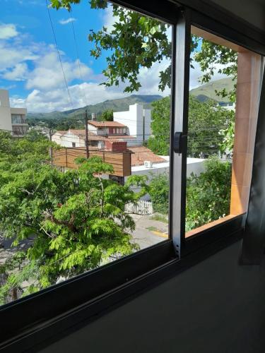 a window with a view of a city at Departamento Centro in La Falda