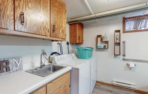a kitchen with a sink and a washing machine at Lilly Pad Landing in Hazelhurst