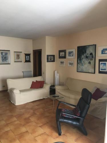 a living room with two couches and a table at Viale Ancona by Ospitaci in Foligno