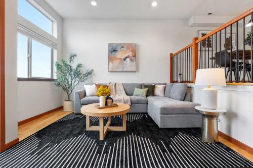 a living room with a couch and a table at LakeView Queen Anne 3BR Townhome in Seattle