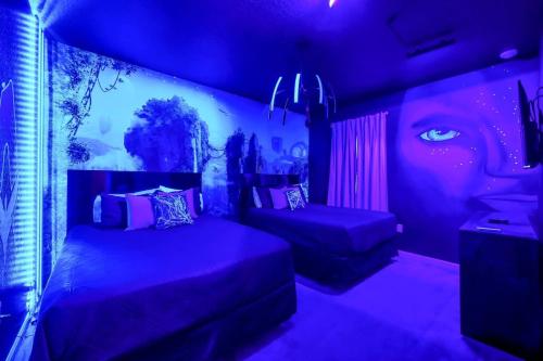 a purple room with two beds and a painting of a face at EPIC 12 Bedroom Home with Private Pool in Kissimmee
