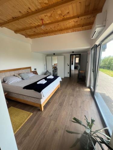a bedroom with a bed and a wooden ceiling at Kucica na Brdu in Brda