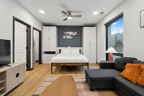 a living room with a bed and a couch at CozySuites Mass with parking lounge & roof deck #24 in Indianapolis