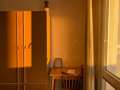 a room with a desk and a cabinet and a table at Apartmán Pod Studenou Horou in Rokytnice nad Jizerou