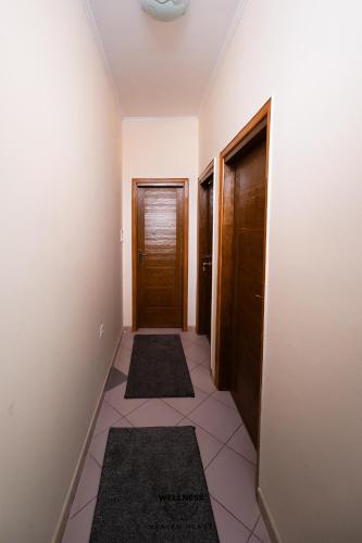 a hallway with two doors and two rugs at Heaven Heart - Apartmani Tuzla in Tuzla