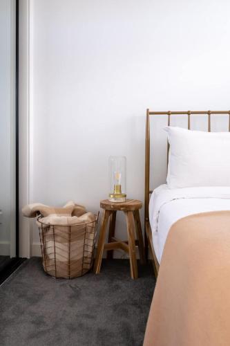 a bedroom with a bed and a table with a lamp at Luxe Altona Haven - Executive 3BR Family Townhouse in Newport