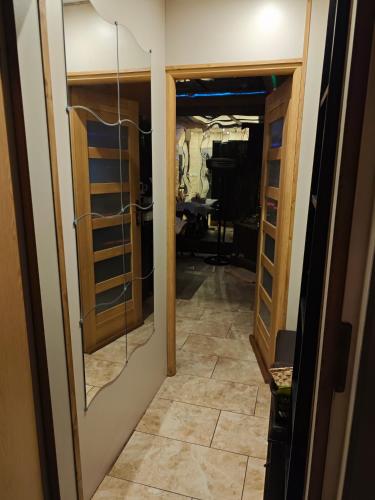 a hallway with a door leading into a room at Komnata solna in Warsaw