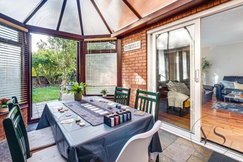 a dining room with a blue table and chairs at 4BR Family Home in 89 Highgate with Jacuzzi, Games Room & Free Parking Near Birmingham in Walsall