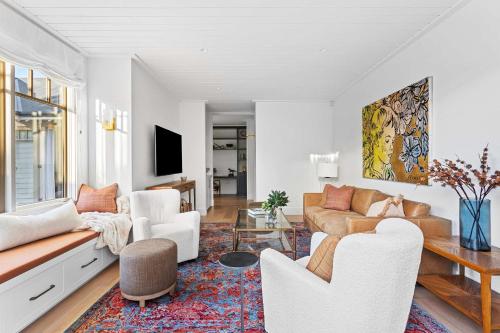 a living room with a couch and a table at Muskoka Luxe Retreat with Pool Spa & Fire Pit in Mount Martha