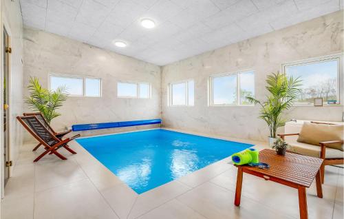 a swimming pool in a living room with a couch and chairs at Lovely Home In Løgstrup With Wifi in Løgstrup