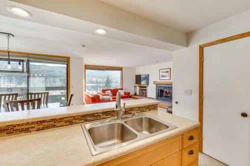 a kitchen with a sink and a living room at 2 Mi to Winter Park Resort: Condo w/ Pool Access! in Winter Park