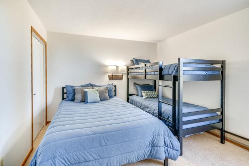 a bedroom with two bunk beds with blue sheets at 2 Mi to Winter Park Resort: Condo w/ Pool Access! in Winter Park