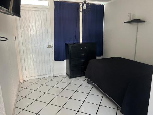 a bedroom with a bed and a dresser and a window at Monoambiente in San Luis Potosí