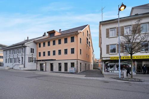 an empty street with a building on the corner at Duplex Apartment Bülach Station in Bülach