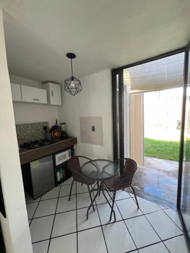 a kitchen with a glass table and chairs in a room at Monoambiente in San Luis Potosí