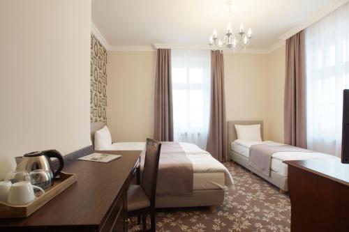 Pokój hotelowy z 2 łóżkami i biurkiem w obiekcie Villa La Pierre w mieście Strzegom