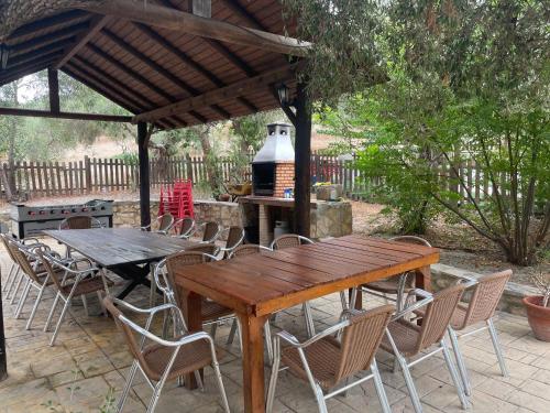 a wooden table and chairs under a pavilion at Casa Rural Privada Belén in Pruna