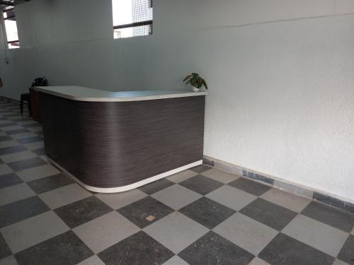a counter with a plant on top of a wall at Hotel Highway Palace in Nashik