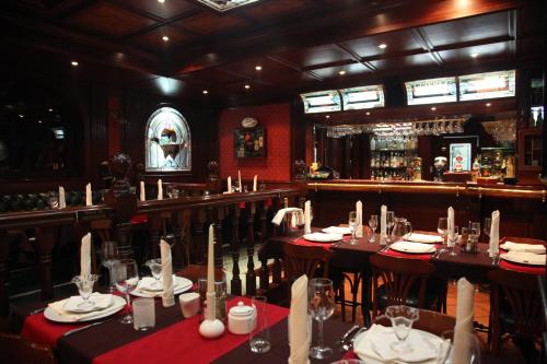 a restaurant with tables set up for a meal at Alpin Borovets, Алпин Боровец in Borovets