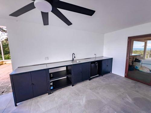 a kitchen with a ceiling fan and a sink at Yunque Reserve Secluded Rainforest House in Hato Candal
