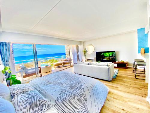 a bedroom with a bed and a view of the ocean at Panoramic Oceanview Resort - Full Kitchen in Each Unit, 2 Swimming Pools, Onsite Restaurants, Fireworks Every Friday in Honolulu