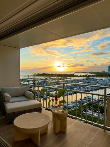 a living room with a balcony with a view of a harbor at Panoramic Oceanview Resort - Full Kitchen in Each Unit, 2 Swimming Pools, Onsite Restaurants, Fireworks Every Friday in Honolulu