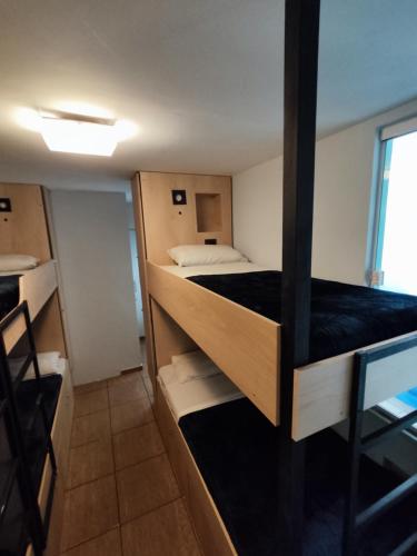a small room with a bed and a window at Mango Tree Ipanema in Rio de Janeiro