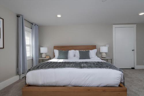 a bedroom with a large bed and two lamps at Updated Family-sized Home in Heart of Rutland, Near Slopes, EV Level 2, Hot Tub in Rutland