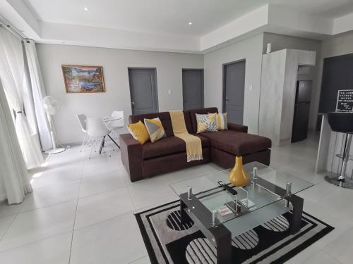a living room with a couch and a table at Executive 2-bedroom Serenity apartment in Wendywood Sandton with its own entrance in Johannesburg