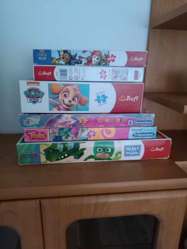a stack of books sitting on top of a table at Apartament Komfort in Przemyśl
