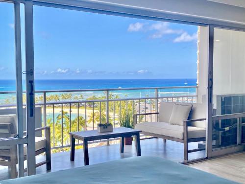 a bedroom with a balcony with a view of the ocean at Panoramic Oceanview Resort - Full Kitchen in Each Unit, 2 Swimming Pools, Onsite Restaurants, Fireworks Every Friday in Honolulu