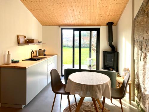 a kitchen and dining room with a table and chairs at Casinha do Sol - Natureza & Lazer - Serra da Freita in Arouca