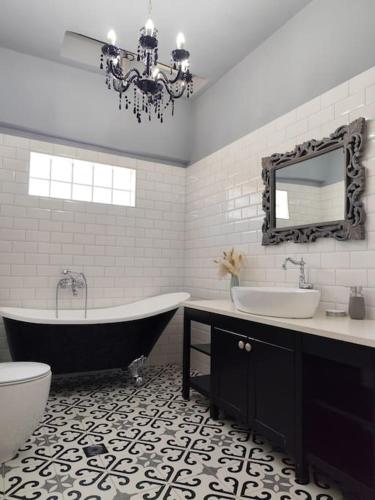 a bathroom with a tub and a sink and a toilet at Thermian Country House in Thermo