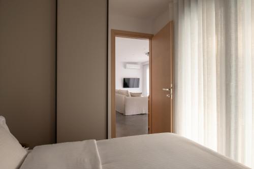 a bedroom with a bed and a view of a living room at Prive Studio in Thessaloniki