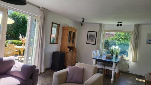 a living room with a table and chairs at Prachtige Vakantiewoning 'la bienvenue' in Venlo, Limburg in Venlo